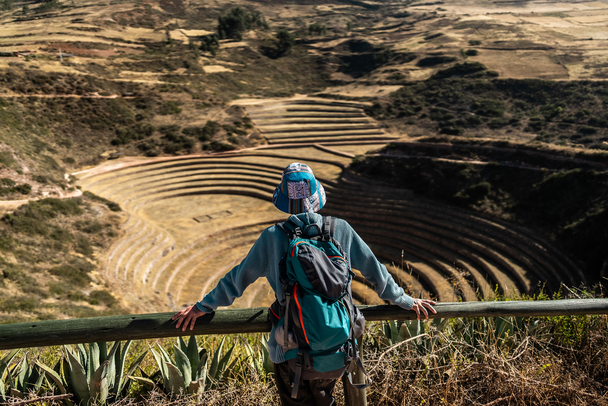 Tourist man looking at view on a mountain, in Moray, Peru