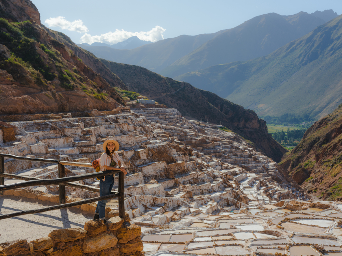 Woman looking at scenic view of Salinas de Maras in Peru