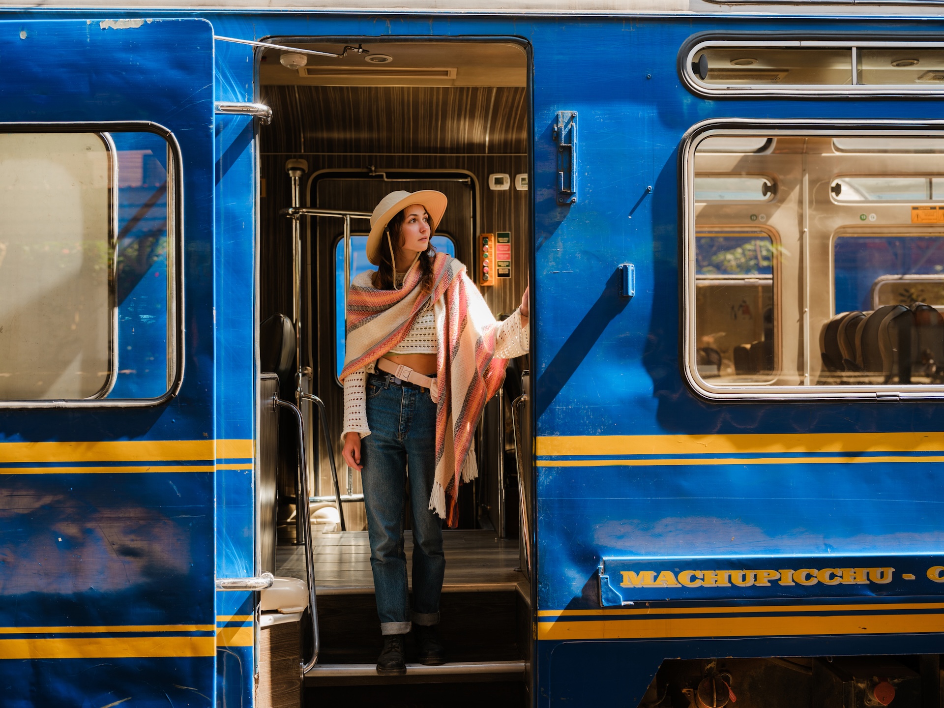 Woman boarding Machu Picchu train in Peru during her experiential trip