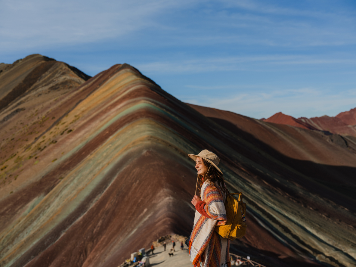 Woman looking at Vinicunca Rainbow mountain during trip to Peru