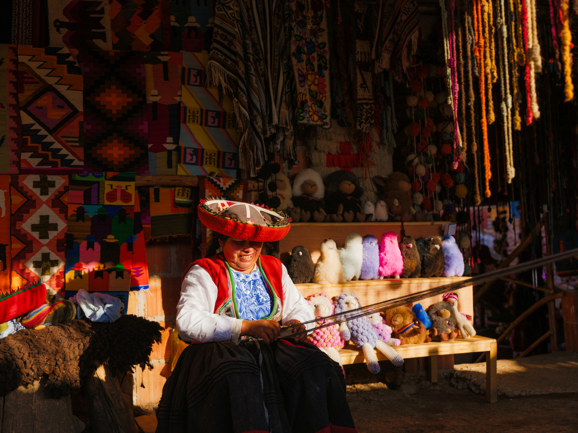 Indigenous woman of Sacred Valley weaving crafts