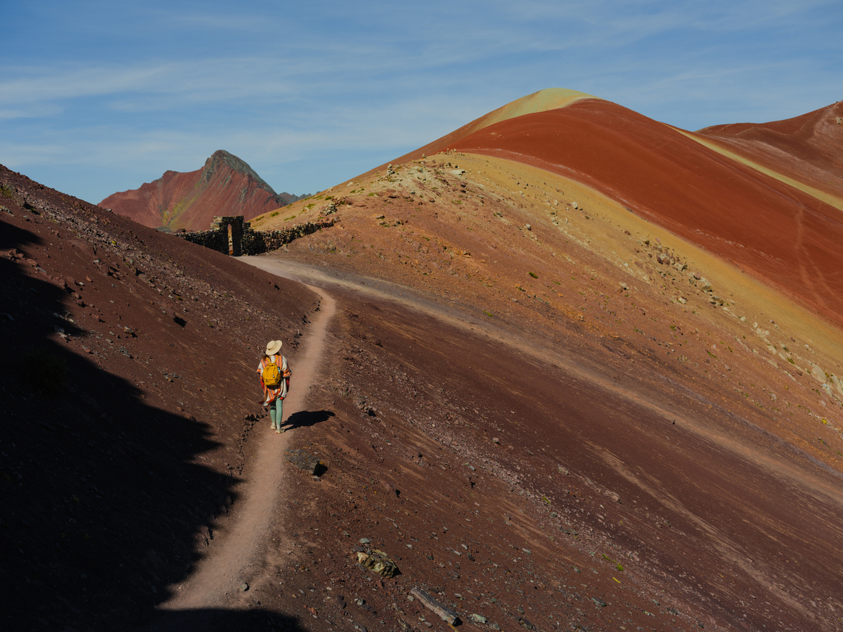Woman looking at Vinicunca Rainbow mountain during trip to Peru