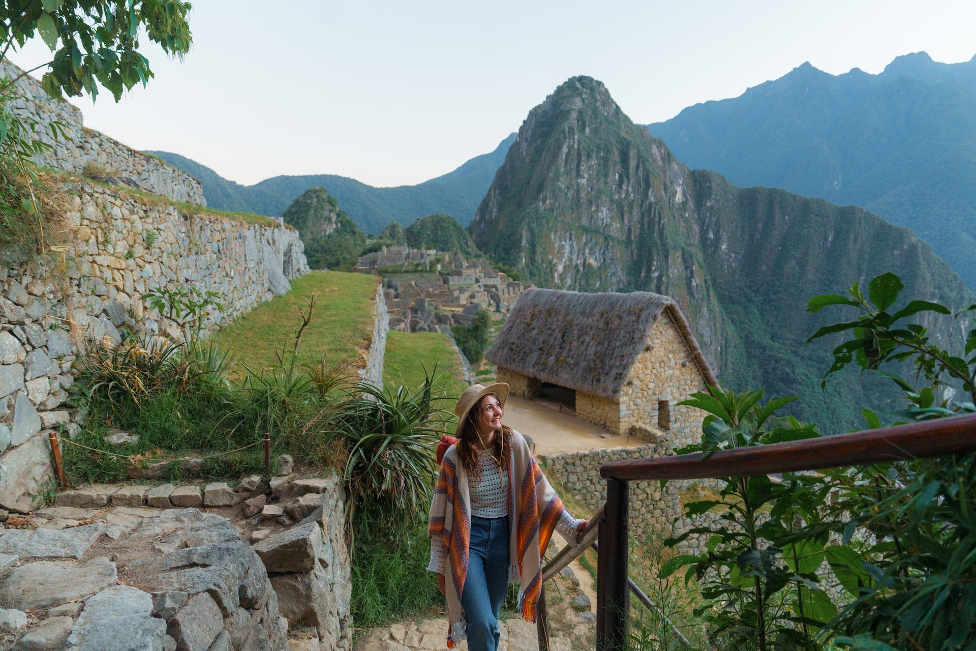 Serene woman exploring Machu Picchu during experiential trip to Peru