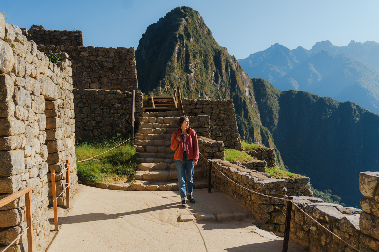 Woman exploring Machu Picchu during trip to Peru